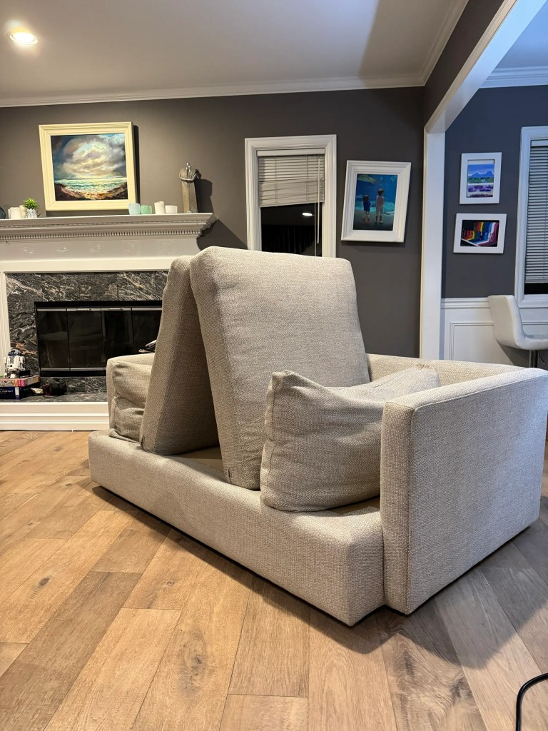 Professional cleaner examining upholstery fabric type before beginning deep cleaning process